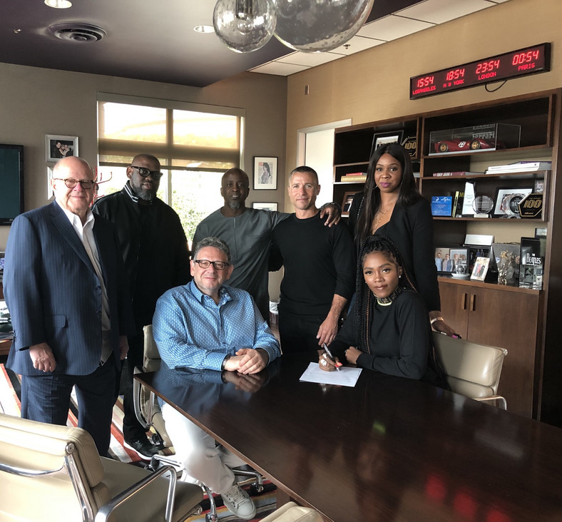 Tiwa Savage signing her record deal with Universal Music Group. (UMG) [Ashley Eberbach]